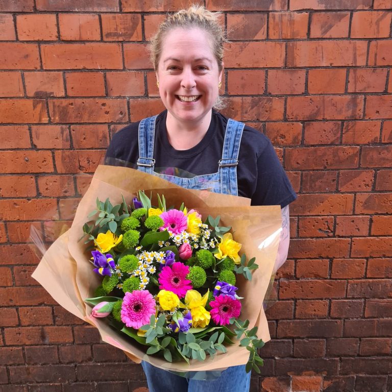 Image of staff member Sinead holding a bouquet