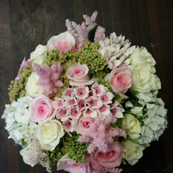 image of a perfectly round bridal bouquet by Adonis featuring soft pinks and white tones