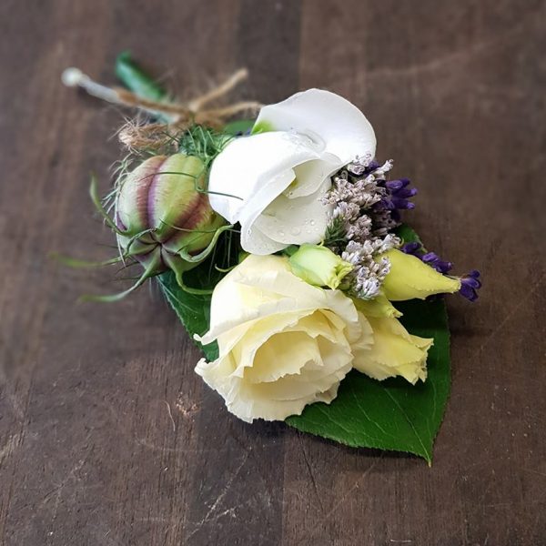 image showing white rose and seed head buttonholes by Adonis