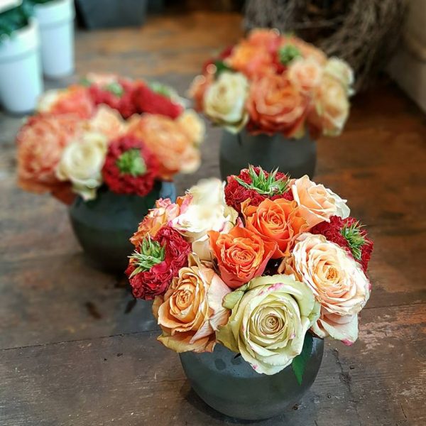 Image showing red, orange and peach roses in medium fishbowl vases