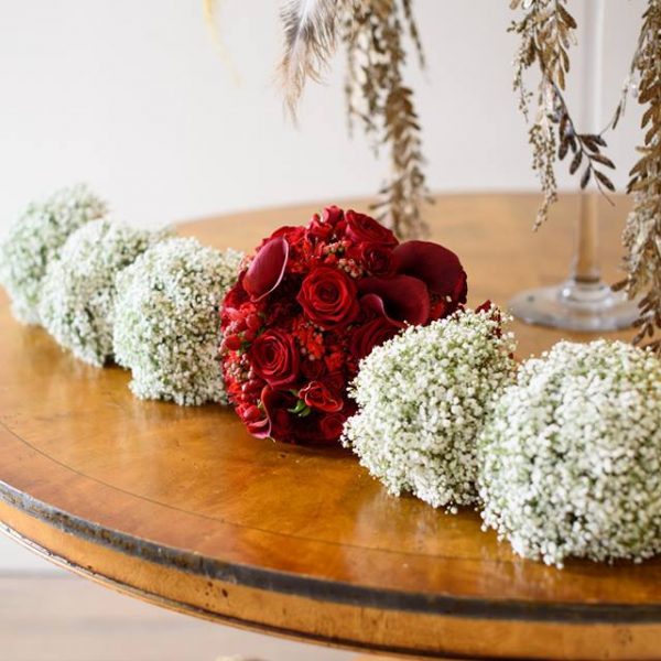 Image of a rich red bridal bouquet among 5 gypsophilia bridesmaids bouquets by Adonis
