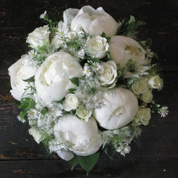image of a compact white peony and rose bridal bouquet by Adonis