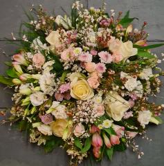 Image of a large funeral posy wreath by Adonis in gentle pastel tones