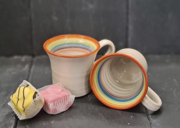 image of two handcrafted, rainbow themed mugs by Irish supplier TomPow pottery