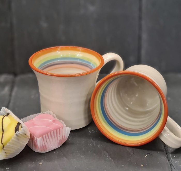 image of two handcrafted, rainbow themed mugs by Irish supplier TomPow pottery
