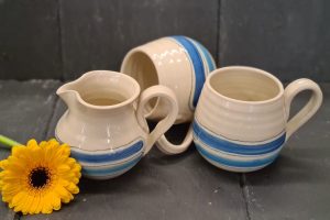 Image of hand crafted, blue striped cups and milk jug by Irish suppllier TomPow pottery