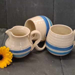 Image of hand crafted, blue striped cups and milk jug by Irish suppllier TomPow pottery