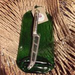 Image of a recycled gin bottle cheese board complete with cheese knife