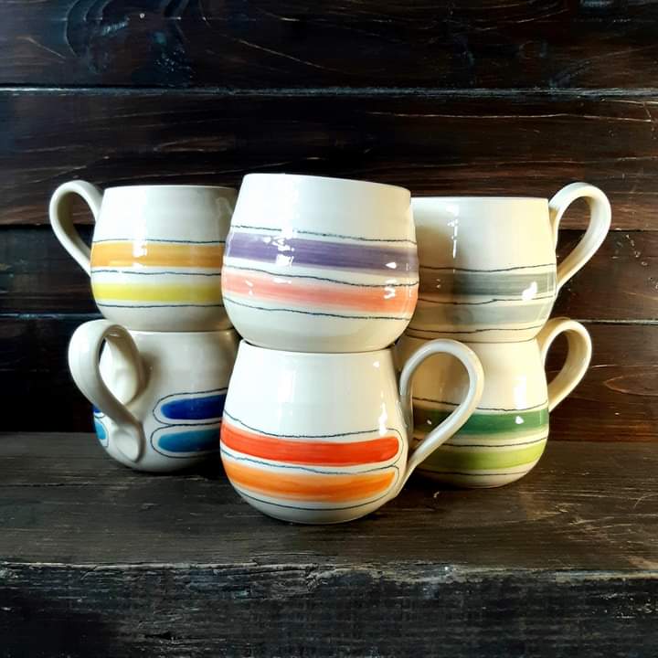 Image of 6 assorted colourful, handcrafted mugs by Irish supplier TomPow Pottery