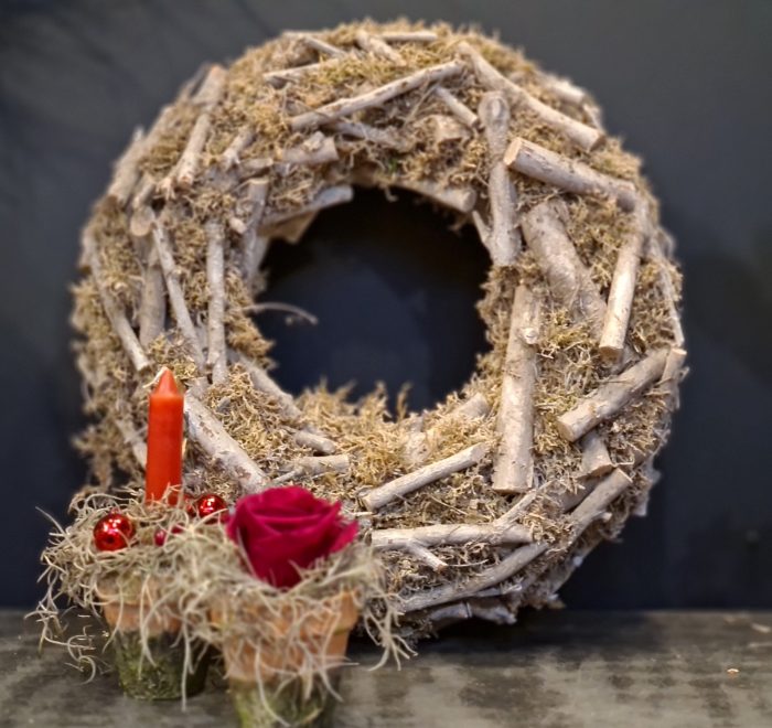 Image of a rustic heavy moss and log wreath
